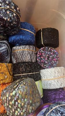 A TOTE PACKED WITH A BUNCH OF CRAFTING STRING/THREAD