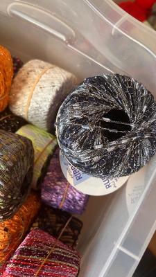 A TOTE PACKED WITH A BUNCH OF CRAFTING STRING/THREAD