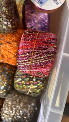 A TOTE PACKED WITH A BUNCH OF CRAFTING STRING/THREAD