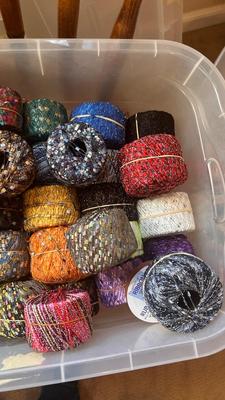 A TOTE PACKED WITH A BUNCH OF CRAFTING STRING/THREAD