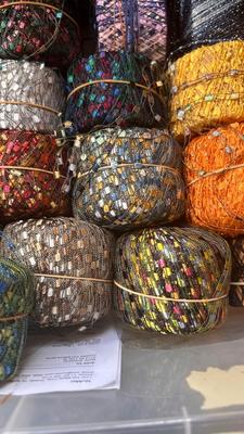 A TOTE PACKED WITH A BUNCH OF CRAFTING STRING/THREAD