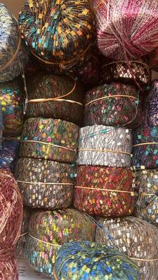 A TOTE PACKED WITH A BUNCH OF CRAFTING STRING/THREAD