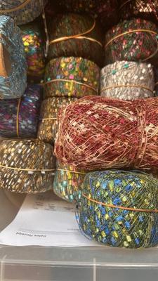 A TOTE PACKED WITH A BUNCH OF CRAFTING STRING/THREAD