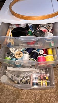 A DRAWER ORGANIZER LOADED WITH SEWING NOTIONS AND OTHER ITEMS