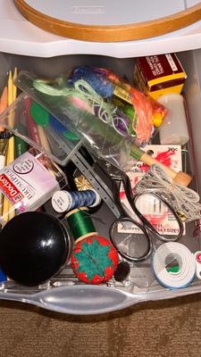 A DRAWER ORGANIZER LOADED WITH SEWING NOTIONS AND OTHER ITEMS
