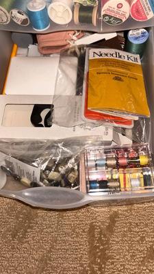 A DRAWER ORGANIZER LOADED WITH SEWING NOTIONS AND OTHER ITEMS