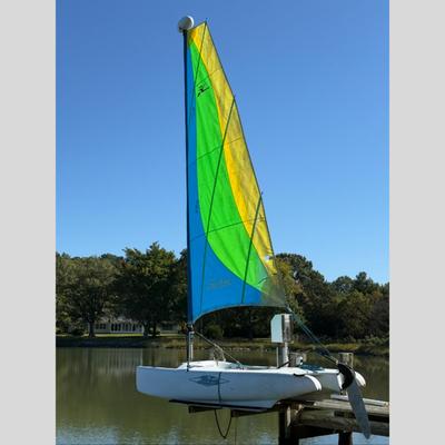 Sale Photo Thumbnail #1592: Catamaran, Bright Yellow, Green & Blue Vertical Panels. Single Sale Rig, Rotomolded hulls, integrated cross bars
Used for recreational sailing
Measures: 12' long x 4'6" wide, weighs roughly 200 lbs, mast height: 19' high
All ropes and lines should be repl