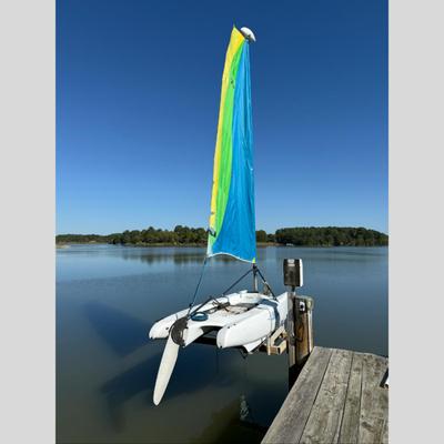 Sale Photo Thumbnail #1591: Catamaran, Bright Yellow, Green & Blue Vertical Panels. Single Sale Rig, Rotomolded hulls, integrated cross bars
Used for recreational sailing
Measures: 12' long x 4'6" wide, weighs roughly 200 lbs, mast height: 19' high
All ropes and lines should be repl