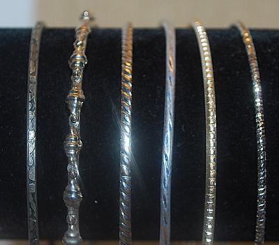 Collection of 6 BANGLE BRACELETS (2½" Opening) with an Assortment of Silver Tone Finishes & Graphics