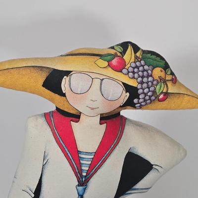 LOT 29Z: Woman with Umbrella in Front of a Hat Shop Print and Mary Engelbreit Here Is My Heart Weighted Fabric Doll