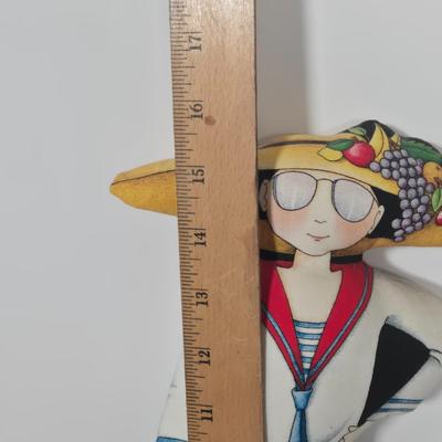 LOT 29Z: Woman with Umbrella in Front of a Hat Shop Print and Mary Engelbreit Here Is My Heart Weighted Fabric Doll