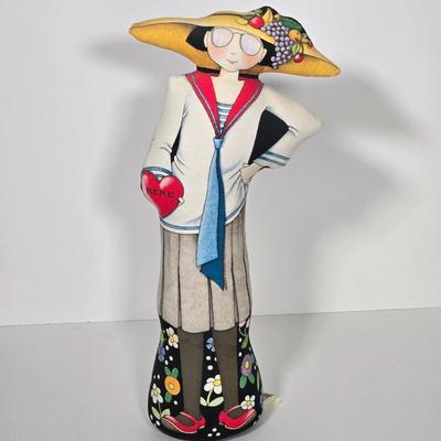 LOT 29Z: Woman with Umbrella in Front of a Hat Shop Print and Mary Engelbreit Here Is My Heart Weighted Fabric Doll