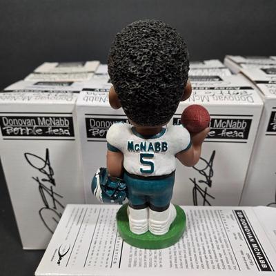 LOT 106Z: NIB Donovan McNabb Bobble Heads/ 5 Home Jerseys, 4 Away