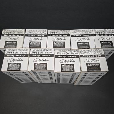 LOT 106Z: NIB Donovan McNabb Bobble Heads/ 5 Home Jerseys, 4 Away