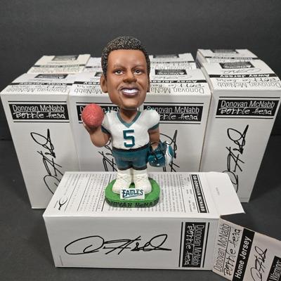 LOT 106Z: NIB Donovan McNabb Bobble Heads/ 5 Home Jerseys, 4 Away