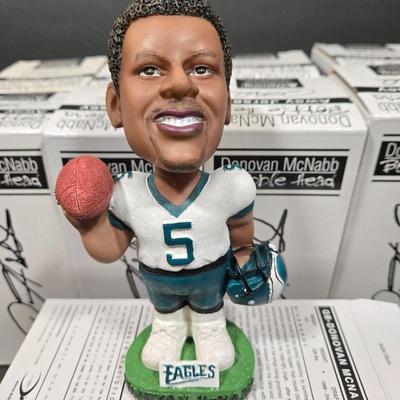 LOT 106Z: NIB Donovan McNabb Bobble Heads/ 5 Home Jerseys, 4 Away