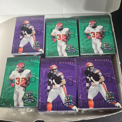 LOT 119Z: Numbered The Football Thesaurus by Deke Houlgate, Football Trading Card Binder with Plastic Protective Sheets, and Playoff NFL...