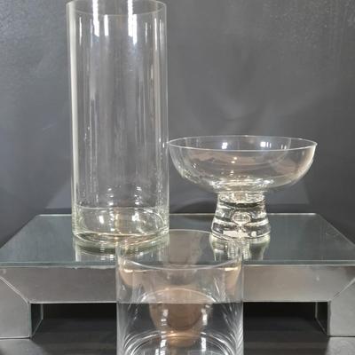 LOT 346B: Block Crystal Pedestal Bowl, Tall Glass Cylinder Vase, Smaller Glass Cylinder Bowl, and Mirror Display Shelf