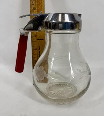 Sale Photo Thumbnail #121: Vintage Etched Floral Glass Syrup Pitcher, chrome lid with red bakelite handle.  Vintage style originally from the 1940's. Great condition.