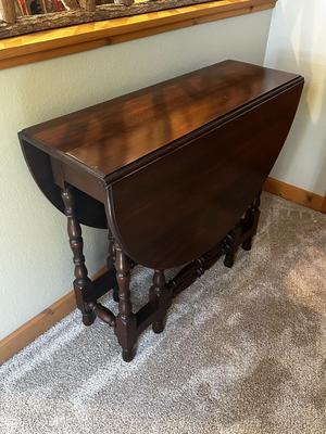 Sale Photo Thumbnail #108: Vintage Gateleg Drop Leaf Table with hinged leaves on both sides that can be raised or folded down.  The leaves are supported by extra legs that swing out.
Full m'ments:
 48" Wide
35" Deep
12" Deep with both sides down