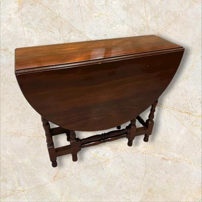 Sale Photo Thumbnail #115: Vintage Gateleg Drop Leaf Table with hinged leaves on both sides that can be raised or folded down.  The leaves are supported by extra legs that swing out.
Full m'ments:
 48" Wide
35" Deep
12" Deep with both sides down