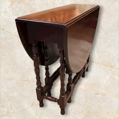 Sale Photo Thumbnail #109: Vintage Gateleg Drop Leaf Table with hinged leaves on both sides that can be raised or folded down.  The leaves are supported by extra legs that swing out.
Full m'ments:
 48" Wide
35" Deep
12" Deep with both sides down