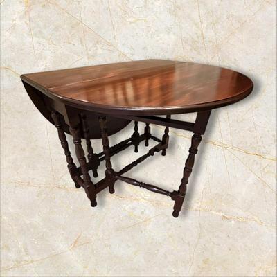 Sale Photo Thumbnail #113: Vintage Gateleg Drop Leaf Table with hinged leaves on both sides that can be raised or folded down.  The leaves are supported by extra legs that swing out.
Full m'ments:
 48" Wide
35" Deep
12" Deep with both sides down