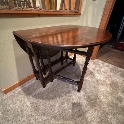 Sale Photo Thumbnail #116: Vintage Gateleg Drop Leaf Table with hinged leaves on both sides that can be raised or folded down.  The leaves are supported by extra legs that swing out.
Full m'ments:
 48" Wide
35" Deep
12" Deep with both sides down