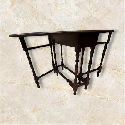 Sale Photo Thumbnail #111: Vintage Gateleg Drop Leaf Table with hinged leaves on both sides that can be raised or folded down.  The leaves are supported by extra legs that swing out.
Full m'ments:
 48" Wide
35" Deep
12" Deep with both sides down