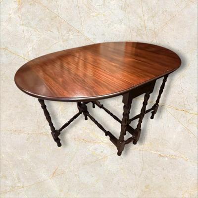 Sale Photo Thumbnail #112: Vintage Gateleg Drop Leaf Table with hinged leaves on both sides that can be raised or folded down.  The leaves are supported by extra legs that swing out.
Full m'ments:
 48" Wide
35" Deep
12" Deep with both sides down