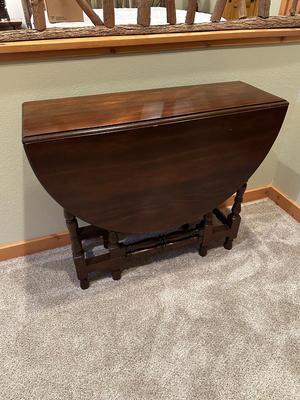 Sale Photo Thumbnail #119: Vintage Gateleg Drop Leaf Table with hinged leaves on both sides that can be raised or folded down.  The leaves are supported by extra legs that swing out.
Full m'ments:
 48" Wide
35" Deep
12" Deep with both sides down