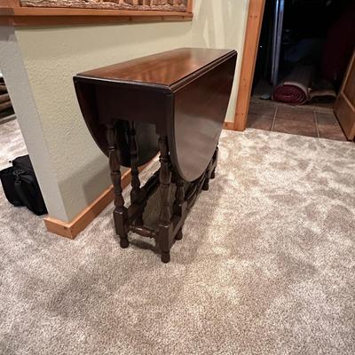 Sale Photo Thumbnail #120: Vintage Gateleg Drop Leaf Table with hinged leaves on both sides that can be raised or folded down.  The leaves are supported by extra legs that swing out.
Full m'ments:
 48" Wide
35" Deep
12" Deep with both sides down