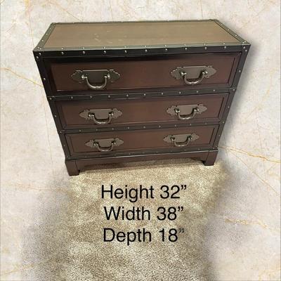 Sale Photo Thumbnail #125: Trunk Style Three Drawer Accent Chest.  This Chest provides storage with a vintage look featuring faux leather accents, metal hardware and decorative studs to resemble an old travel trunk. By Sunforce Furniture. 
M'ments:
Height 32"
Width 38"
Depth 18"