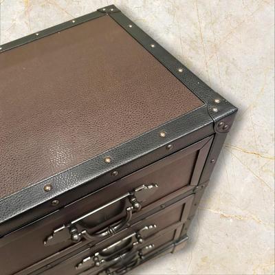 Sale Photo Thumbnail #124: Trunk Style Three Drawer Accent Chest.  This Chest provides storage with a vintage look featuring faux leather accents, metal hardware and decorative studs to resemble an old travel trunk. By Sunforce Furniture. 
M'ments:
Height 32"
Width 38"
Depth 18"