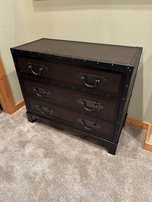 Sale Photo Thumbnail #126: Trunk Style Three Drawer Accent Chest.  This Chest provides storage with a vintage look featuring faux leather accents, metal hardware and decorative studs to resemble an old travel trunk. By Sunforce Furniture. 
M'ments:
Height 32"
Width 38"
Depth 18"
