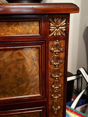 Sale Photo Thumbnail #228: Eglomise Handcrafted 3 Drawer Dresser by Theodore Alexander
Measurements: 46" WIde x 34" Tall x 20" Deep
"Eglomise" refers to a decorative technique using glass with metallic leaf applied to the reverse which Alexander used for many of his pieces.