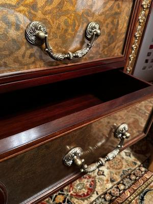 Sale Photo Thumbnail #231: Eglomise Handcrafted 3 Drawer Dresser by Theodore Alexander
Measurements: 46" WIde x 34" Tall x 20" Deep
"Eglomise" refers to a decorative technique using glass with metallic leaf applied to the reverse which Alexander used for many of his pieces.