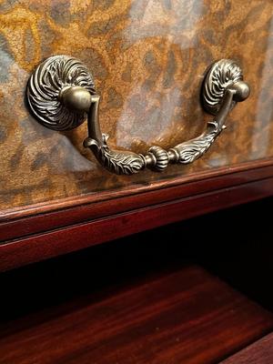 Sale Photo Thumbnail #230: Eglomise Handcrafted 3 Drawer Dresser by Theodore Alexander
Measurements: 46" WIde x 34" Tall x 20" Deep
"Eglomise" refers to a decorative technique using glass with metallic leaf applied to the reverse which Alexander used for many of his pieces.