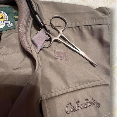 Sale Photo Thumbnail #452: Cabela's Fishing Vest with Pockets Galore +Accessories Size Large
Needs to be washed, there is some sticky unknown residue on parts of it.