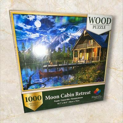 Sale Photo Thumbnail #885: Box of Puzzles, 1 Sealed
Moon Cabin Retreat is sealed and has 1000 wood pieces.