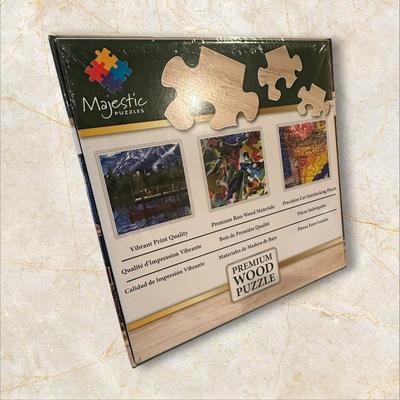 Sale Photo Thumbnail #886: Box of Puzzles, 1 Sealed
Moon Cabin Retreat is sealed and has 1000 wood pieces.