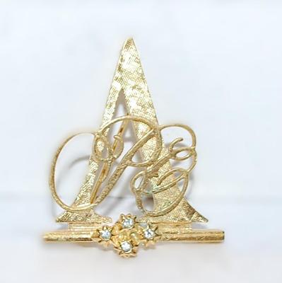 Gold Colored TRIANGLE BROOCH (1¼" x 1¼") with a Script Design and 4 Accent Stones on a Gold Tone Setting