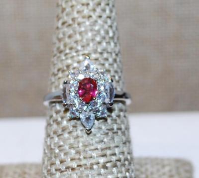 Size 7 Small Oval Red Center Stone Ring with Full "Diamond" Shaped Surround on a Silver Tone Band (2.5g)