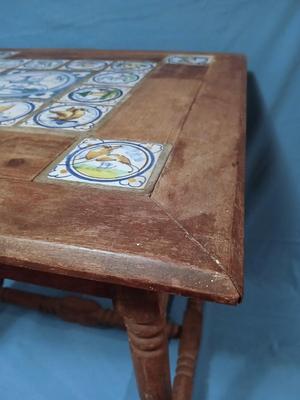 Sale Photo Thumbnail #12: Charming antique hand painted tiles of animals, buildings, trees in Medieval style. Wear corresponding to age. Nice golden color to wood. 22 1/2" W x 22 1/2" D x 22 1/2" H. Loose trim piece from underside included.