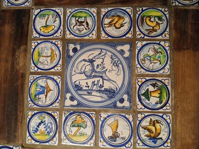 Sale Photo Thumbnail #7: Charming antique hand painted tiles of animals, buildings, trees in Medieval style. Wear corresponding to age. Nice golden color to wood. 22 1/2" W x 22 1/2" D x 22 1/2" H. Loose trim piece from underside included.