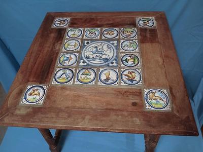 Sale Photo Thumbnail #4: Charming antique hand painted tiles of animals, buildings, trees in Medieval style. Wear corresponding to age. Nice golden color to wood. 22 1/2" W x 22 1/2" D x 22 1/2" H. Loose trim piece from underside included.
