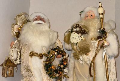 Two Santas Dressed in White and Gold