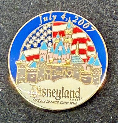 Sale Photo Thumbnail #449: Round pin with the Sleeping beauty Castle and an American flag. Great condition.