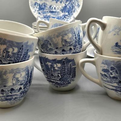 LOT 131: Enoch Wedgwood Tunstall Countryside Pieces Including 12 Cups, 17 Saucers, Creamer, and Sugar/ Storage Cases Included