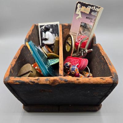 LOT 139: Primitive Wooden Box Filled with Treasures Such as Bucking Bronco and Cowboy Brass Zippo Lighter, Hixon Lumber Co. Tape Measure,...